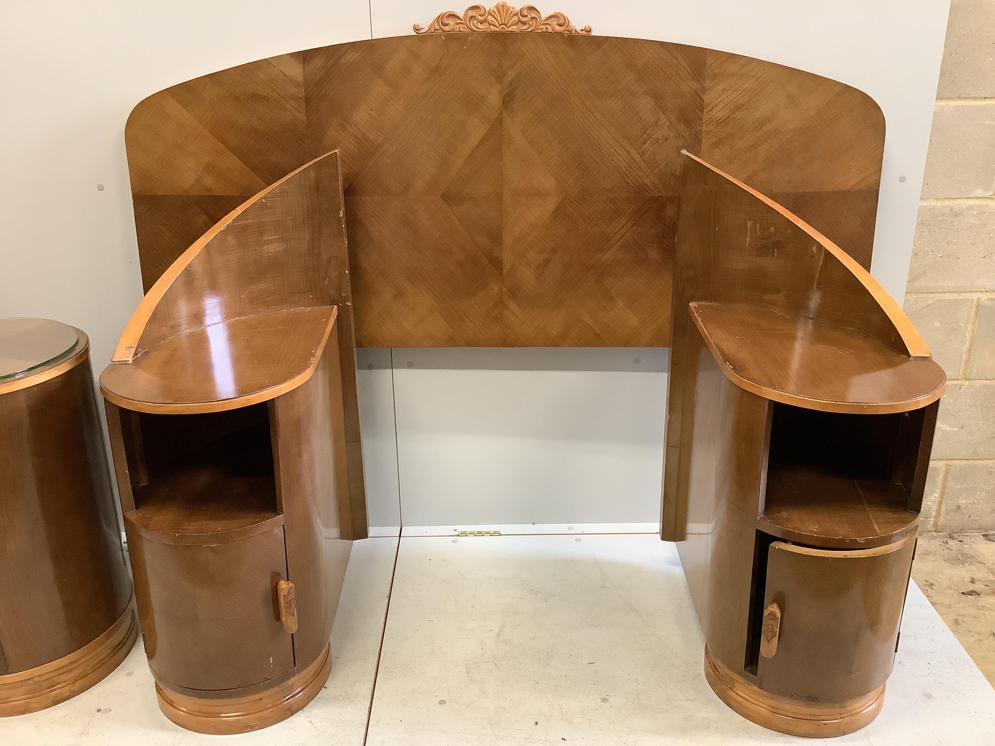 An Art Deco curved walnut dressing table, width 160cm, depth 106cm, height 156cm together with a matching headboard with integral bedside cabinet, width 238cm, height 126cm